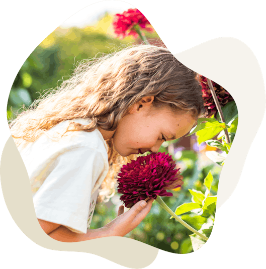 Girl smelling flower