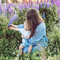 Mom and baby sitting in flowers